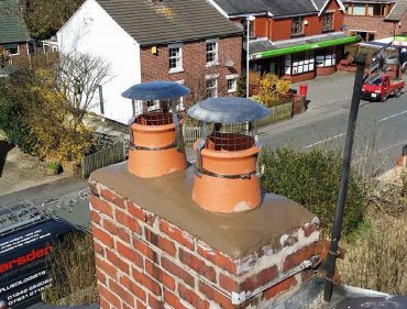 New chimney pot and cowl fitted on a roof